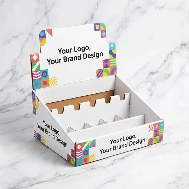 Empty cardboard counter display unit (CDU) and PDQ display box for retail checkout counter keychain merchandising, on a white marble background.