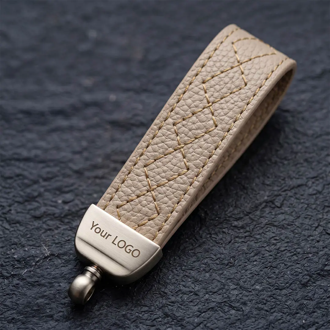 Heavy brushed gunmetal zinc alloy hardware securing a woven microfiber cord, featuring high-precision laser etching for complex OEM corporate messaging.