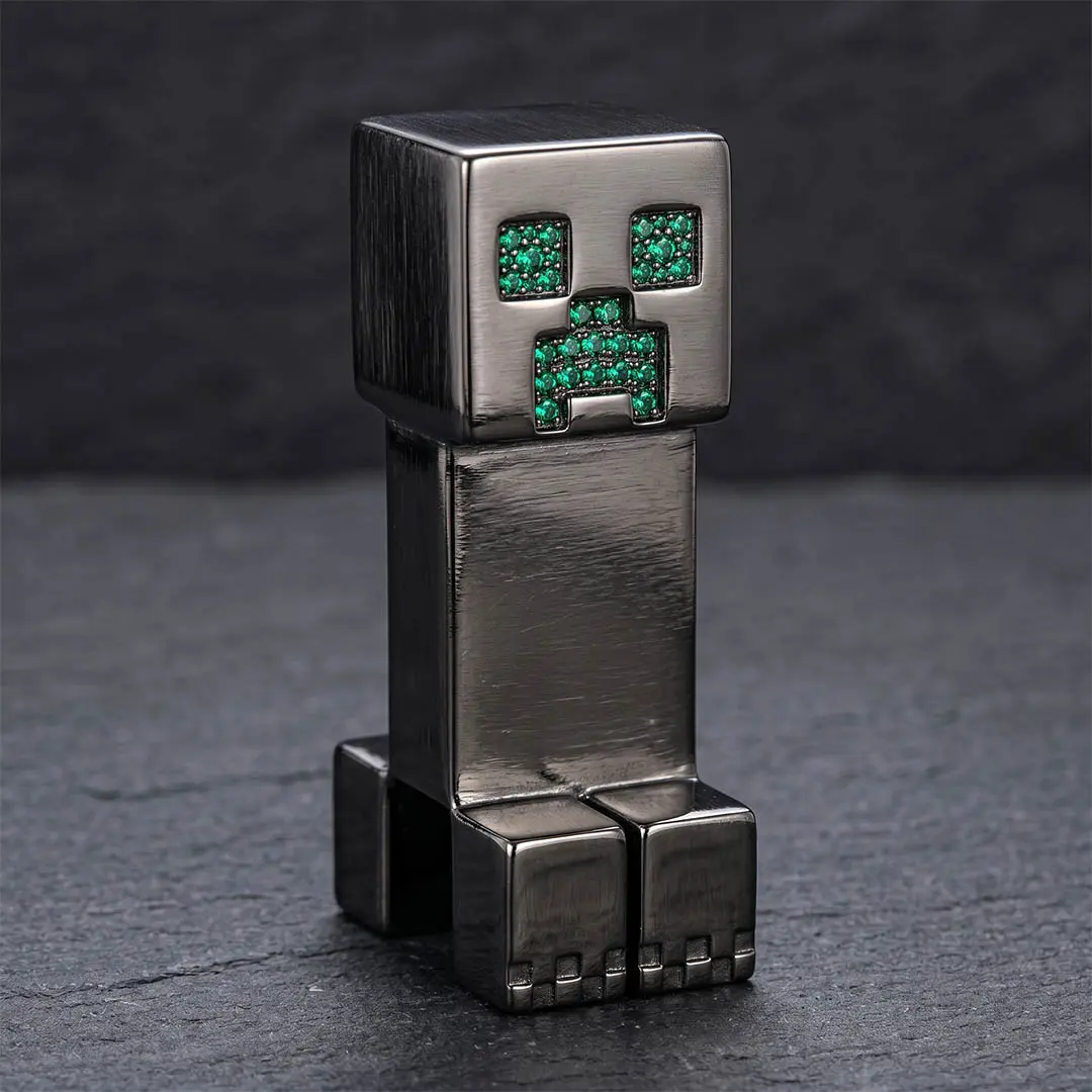 Luxury brushed gunmetal custom hardware desk idol featuring brilliant-cut emerald green 5A CZ stones, representing our highest-tier VIP corporate gifting manufacturing capability.