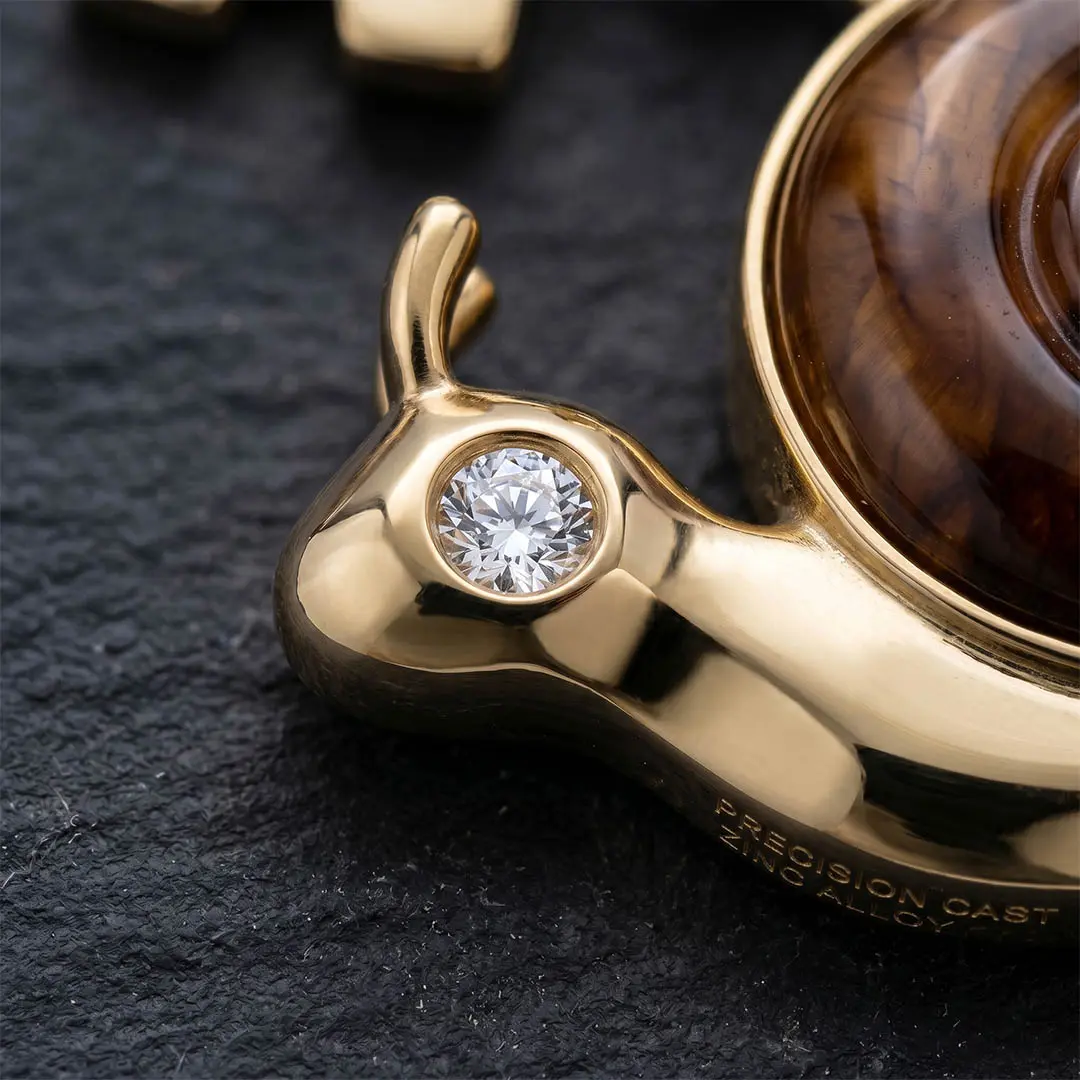 Precision CNC cavity accent featuring a single brilliant-cut crystal deeply set in a polished gold bespoke hardware corporate lapel pin.