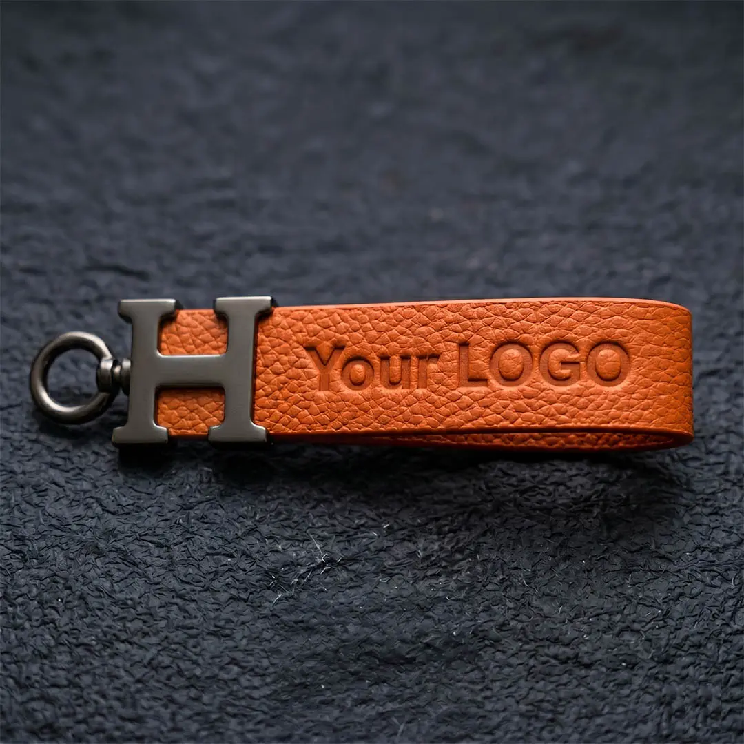 Thick black microfiber leather strap featuring a deep, precise heat debossed logo without ink, demonstrating our Tier 2 executive upgrade for cruelty-free corporate gifting.