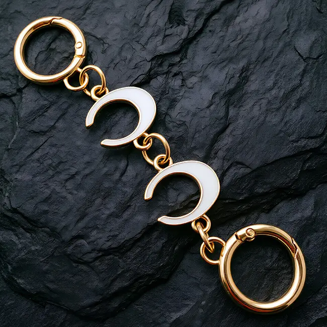 Vista principal de cadenas decorativas para bolsos al por mayor mostrando extensor de 140mm con eslabones de letra C mayuscula en esmalte blanco y herrajes dorados