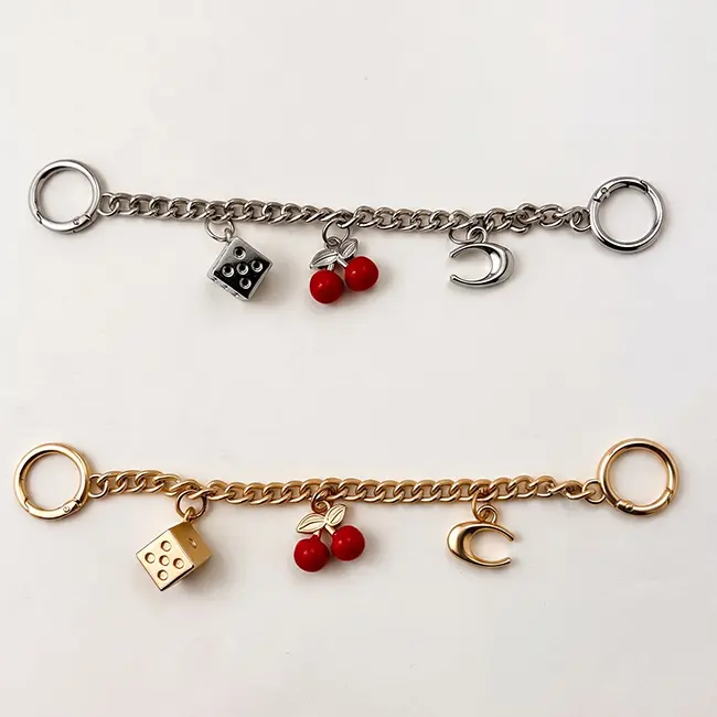 Vista principal de cadenas decorativas de 230mm en plata y oro claro con dado de aleacion de zinc cerezas rojas esmaltadas y luna creciente