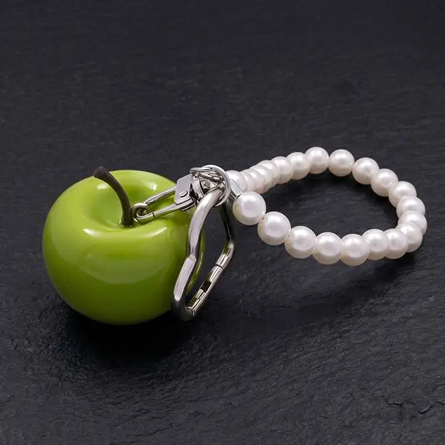 A premium high-gloss green eco-resin apple keyring bag charm showing a durable polished silver-toned zinc alloy heart-shaped clasp and an elegant decorative strand loop of lustrous white faux pearls.