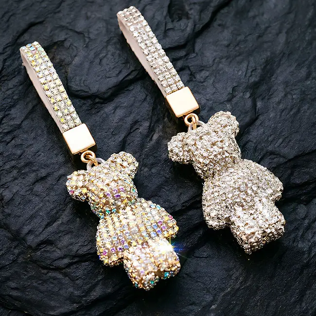 A macro view of the rainbow and white crystal factory direct pavé charms showcasing the full body optical rhinestone inlaid bear motifs, highlighting the precise stone setting and brilliant light refraction quality.