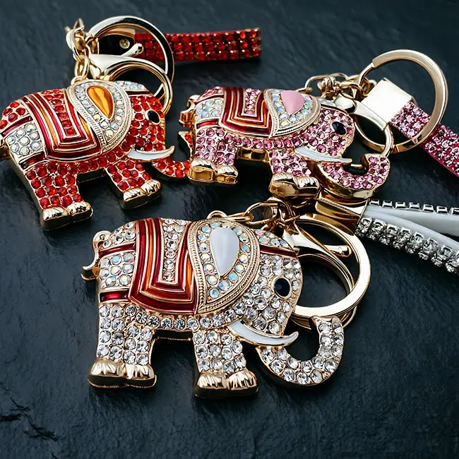 A hardware assembly close up view of the custom crystal inlaid components highlighting the brilliant iridescent clear optical rhinestones, rich red enamel-infill blanket, and heavy duty zinc alloy clasp.